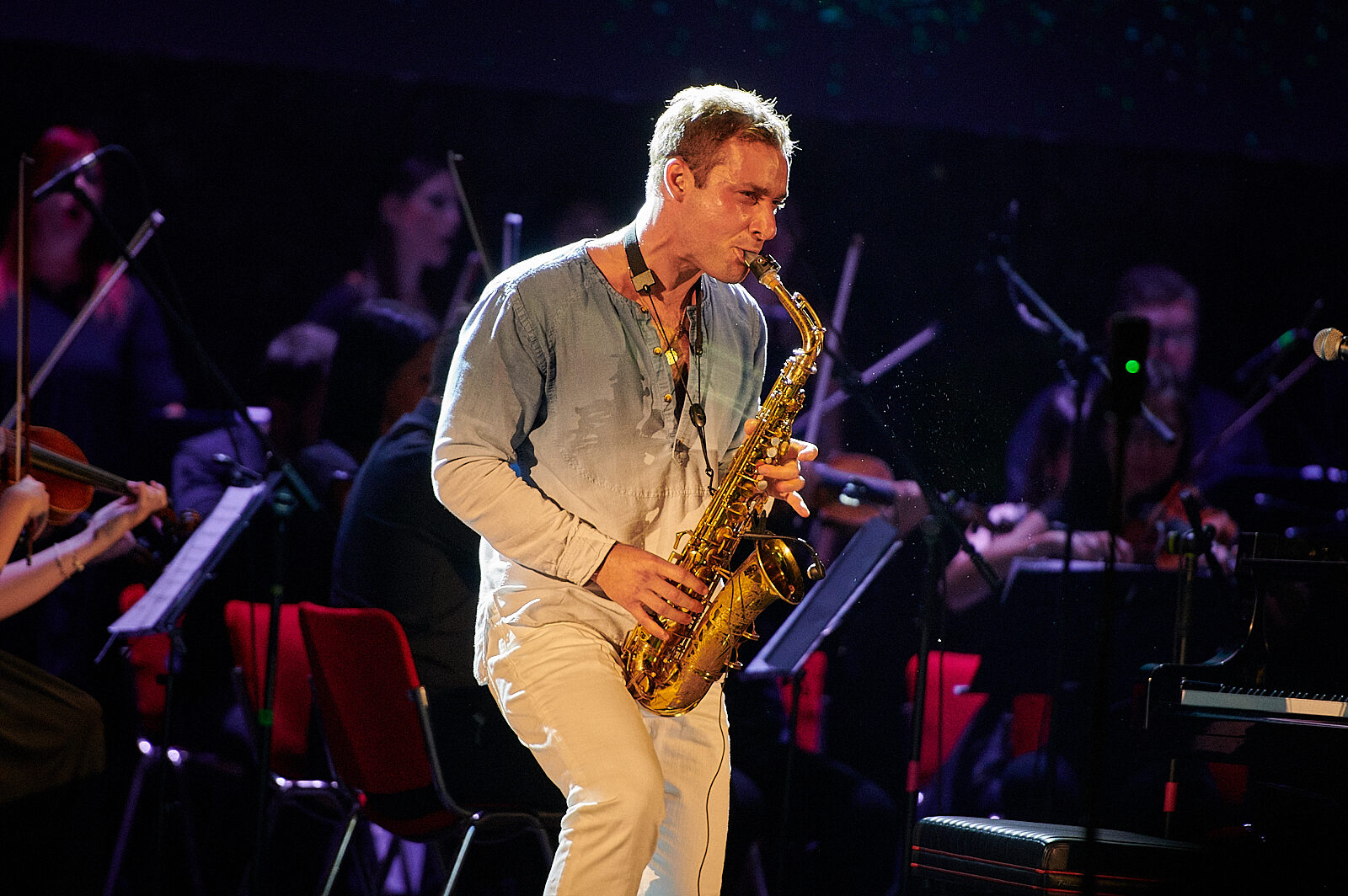 Sapphire Adizes playing saxophone with orchestra